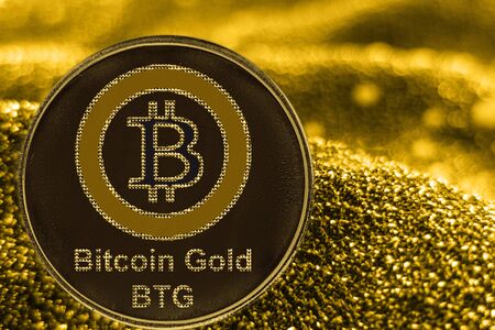 Coin cryptocurrency BTG and gold fabric background. Bitcoin Gold logo.の写真素材