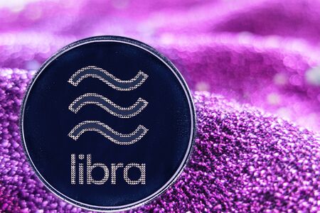 Token cryptocurrency libra  and neon fabric background.の写真素材