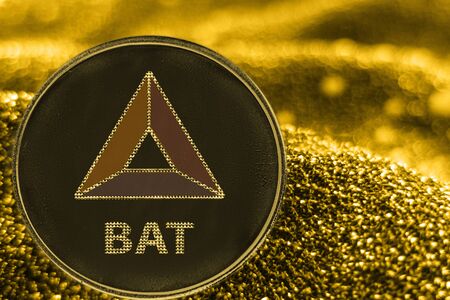 Coin cryptocurrency BAT cahs token on golden background.の写真素材