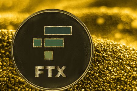 the coin cryptocurrency ftx token on golden background.の写真素材
