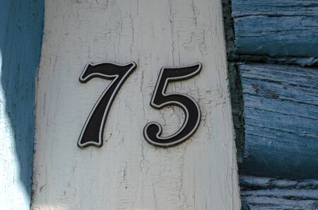 part of the wall of an old wooden house painted blue. paint peeling in places