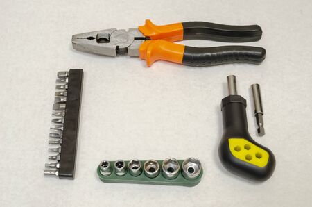 auto mechanic tools are arranged in a frame on a flat surface