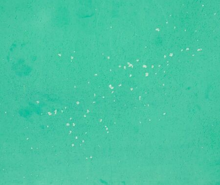 lumps of snow on a green metal gateの写真素材