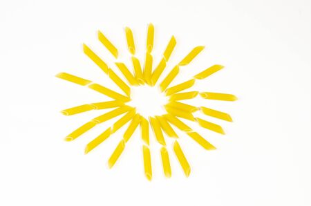 Sun made with fusilli pasta on white background, top viewの写真素材