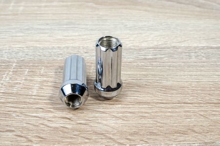 car wheel nuts isolated on table background, auto parts wheel nuts. Close-up of various steel nuts