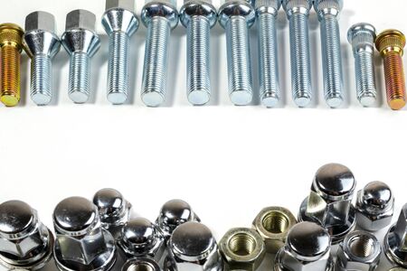 on a white background close-up new shiny nuts and bolts for car wheels with a place for inscription