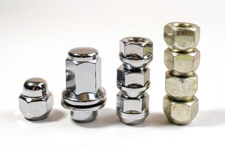 on a white background closeup new shiny nuts and bolts for car wheelsの写真素材