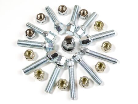 on a white background closeup new shiny car nuts and boltsの写真素材