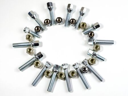 on a white background closeup new shiny car nuts and boltsの写真素材