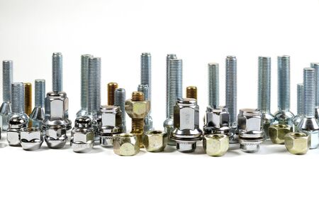 on a white background closeup new shiny car nuts and boltsの写真素材