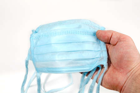 Man holds a protective mask in his hand