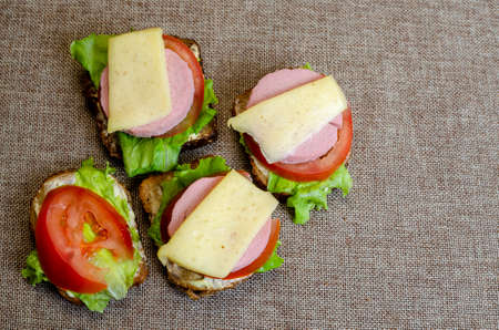 tasty sandwiches with vegetables, cheese and meat, healthy eating conceptの写真素材