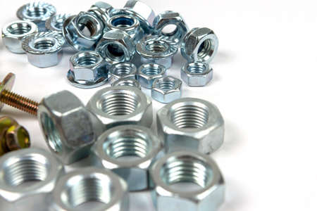 yellow bolts with washers and shiny nuts on a white background