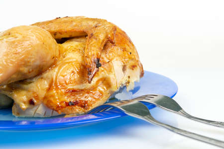 grilled chicken in a dish on a white plate