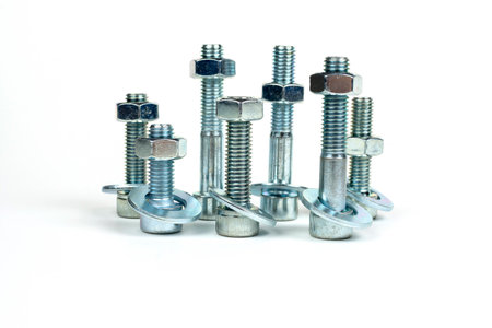 on a white background, galvanized metal fasteners assembled in a set