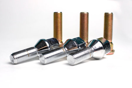 chrome-plated wheel bolts and studs for the car on a white backgroundの写真素材