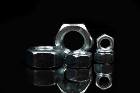 several metal nuts on a white background
