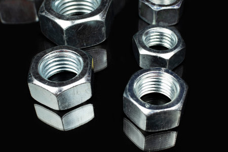 large metal nuts close up on black background