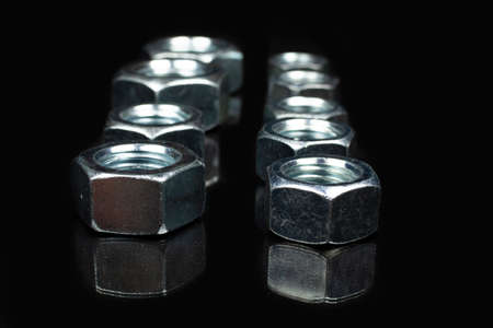 large metal nuts close up on black background