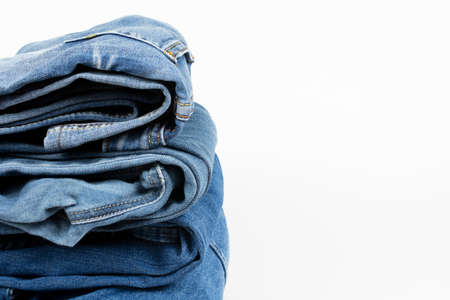 stack of denim clothes on white backgroundの写真素材