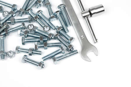bolts with nuts screwed on them, a wrench and a head with a place for copy space
