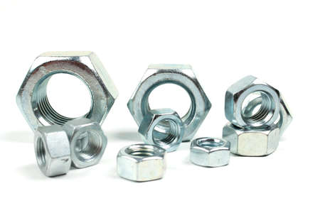 group of silver metal nuts close up on white background
