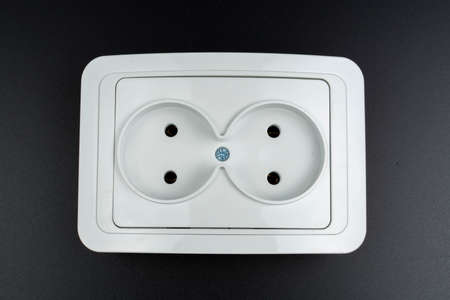 white electrical socket for appliances on a black background