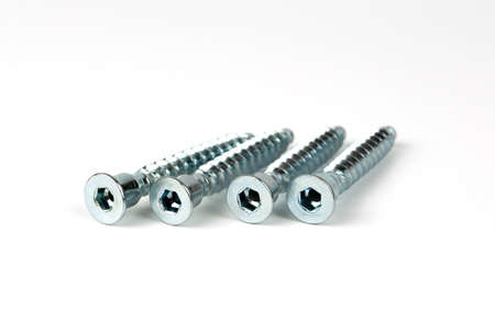 a group of large self-tapping screws for assembling cabinet furniture. isolated on white background