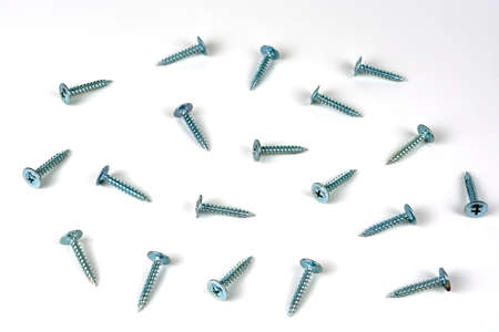 abstract background. shiny self-tapping screws for metal on a white backgroundの写真素材