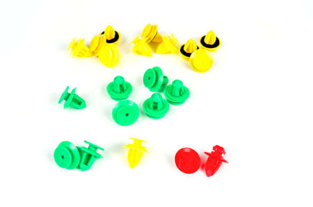 Plastic clips for cars of different colors. Close up. Isolated on white background