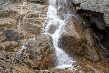 high waterfall on a small river among the rocks