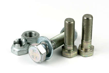 Large metal nuts with silver metal bolts. Close-up on a white background. A group of several nuts...