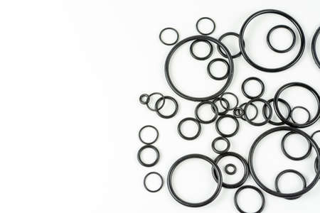 Black hydraulic and pneumatic o-rings in different sizes on a white background. O-rings for...