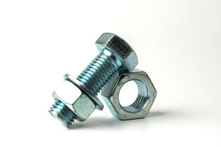 large bolt made of silver metal. Bolts, nuts and washers on a white background close upの写真素材