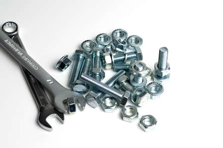 several open-end metal wrenches for working with bolts. Close-up on a white background. Silver metal fixing bolts and nuts. Copy spaceの写真素材