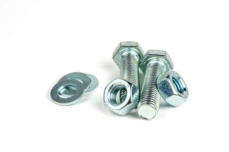 several metal bolts with washers and nuts on a white background. close up