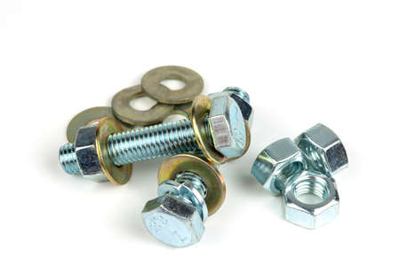 several metal bolts with washers and nuts on a white background. close up