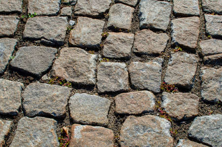 abstract background. pavement in the city park made of granite stonesの写真素材