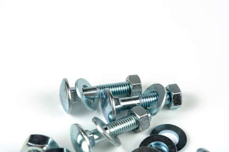 metal bolts and nuts with round washers close-up on a white background. copy space