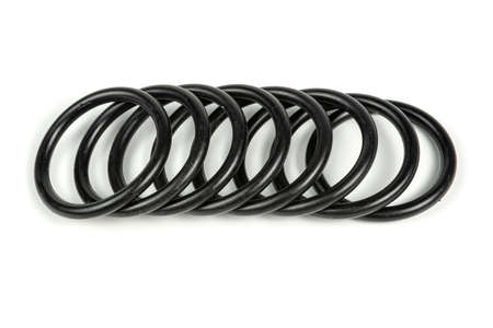 Hydraulic and pneumatic o-rings in black in different sizes on a white background. Various seals for...