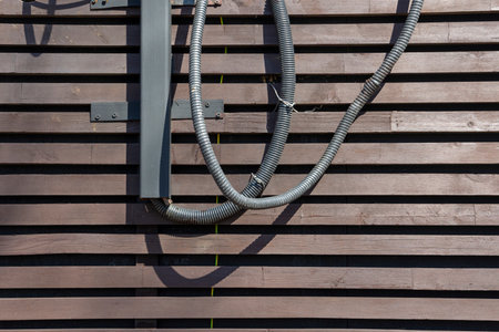 wires on the wall of a wooden building. old wooden building in the city or countryside. facade of an...