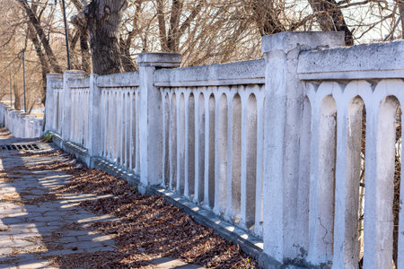 river embankment fencing railing for safe walks of people in the park. warm autumn day