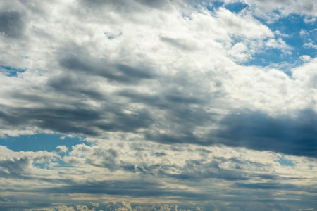 Blue sky, clouds, background, beautiful landscape with heavy thunderclouds. Nature waiting for stormの写真素材
