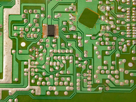 Concept of modern technology. Concept of electronics and microcircuits. Capacitors and resistors on greenの写真素材