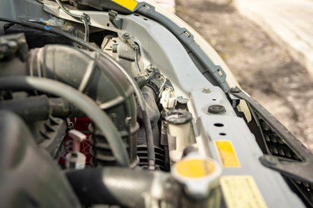 Detailed view of a modern car engine with exposed elements under the hood. Close-ups of various...