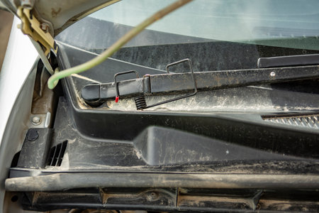 Close-up of a windshield wiper blade cleaning a car windshield from dust and rain. Sunny spring dayの写真素材