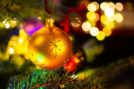 Christmas decorations on the Christmas tree illuminated with colorful lights.の写真素材