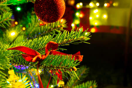 Christmas decorations on the Christmas tree illuminated with colorful lights.の写真素材