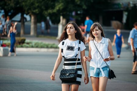 Yessentuki, Stavropol Territory / Russia - August 12, 2017: two young girl friends walking down the street in summer portraitのeditorial素材