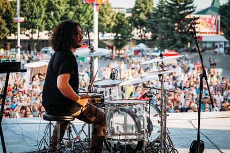 Yessentuki, Stavropol Territory / Russia - August 12, 2017: drumfest drummers festival.musician on stage playing drumsticks on drums Outdoors young man plays drums on stage on concert at outdoor in background of crowdのeditorial素材